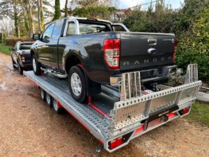 Ford Ranger towing vehicle on recovery trailer in the UK